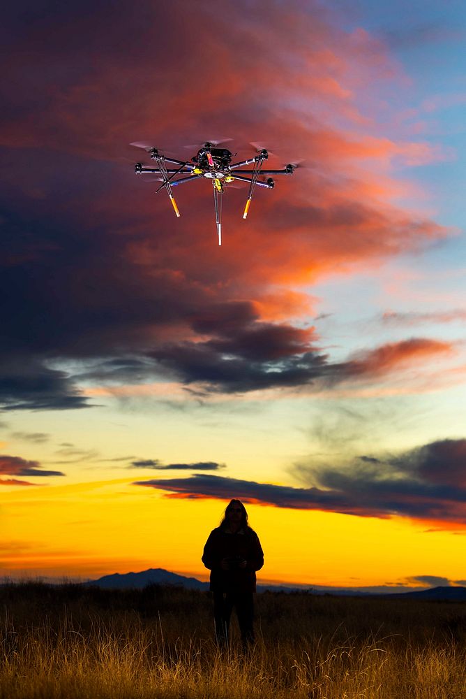 A pilot flies an unmanned aerial vehicle at dusk.