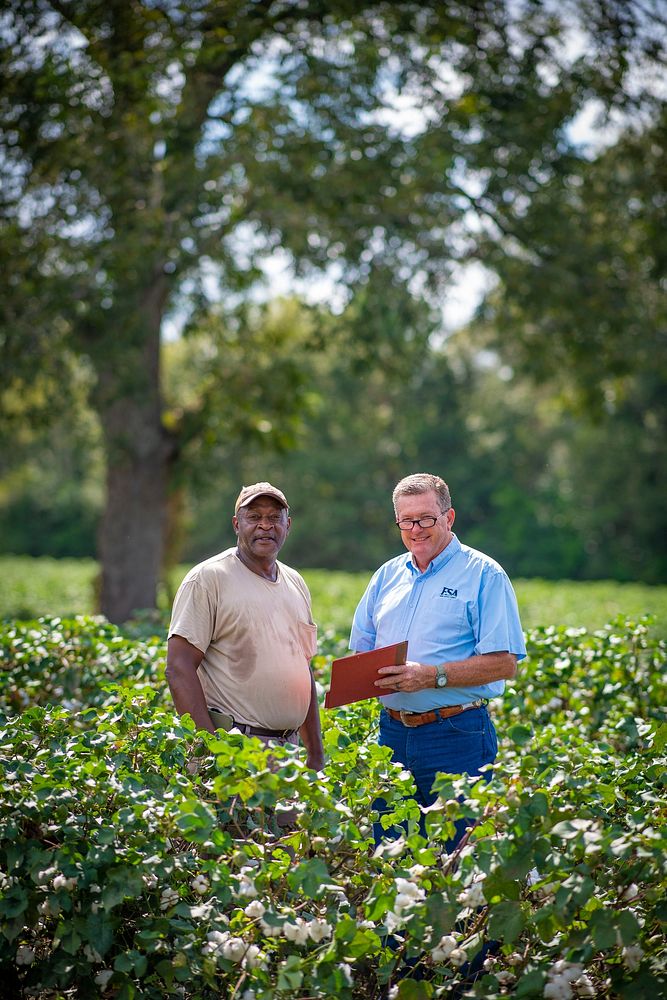 U.S. Department of Agriculture (USDA) Farm Service Agency (FSA) Loan Officer talks with Rick Davis Farms owner Rick Davis in…