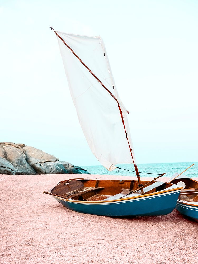 Sailboat on pink sand background, pastel beach