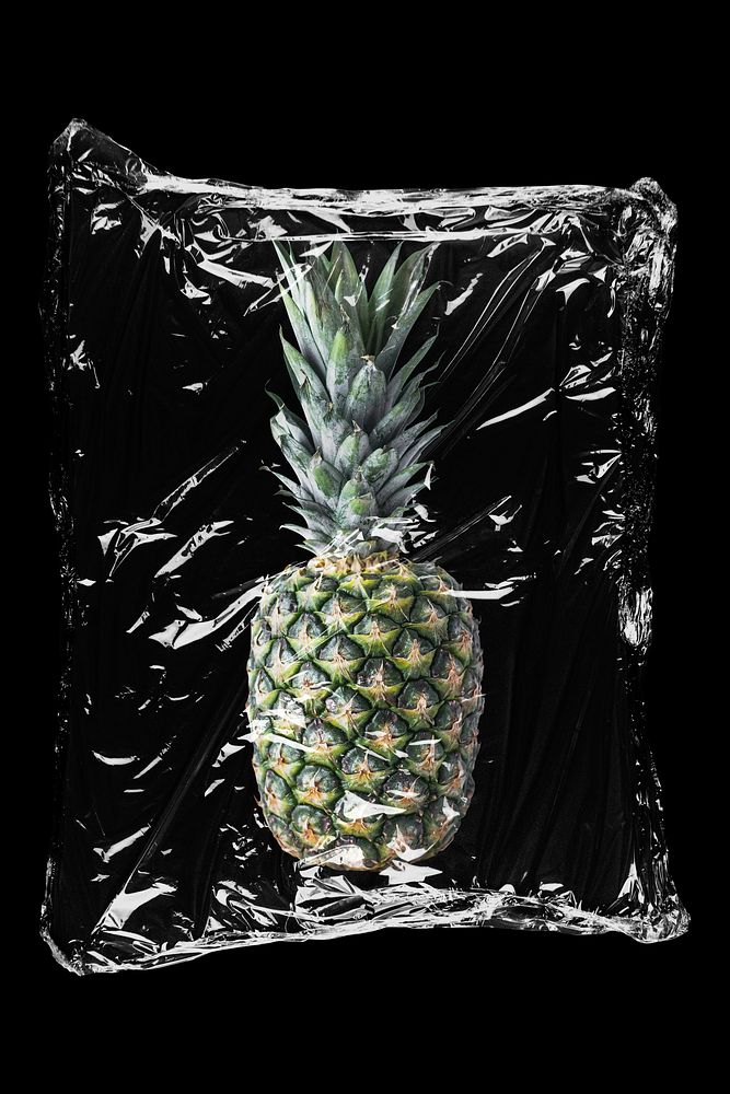 Pineapple in plastic, black background