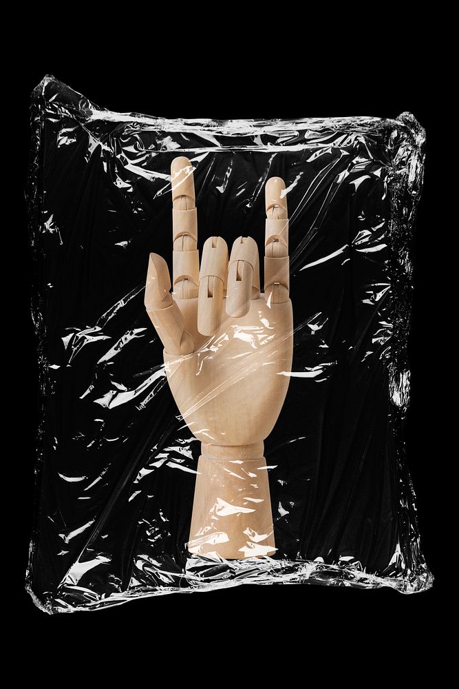 Wooden hand in plastic, black background