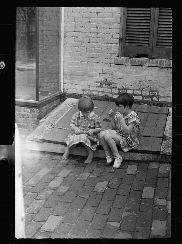 Small girls sitting on cellar door, Georgetown, Washington, D.C.. Sourced from the Library of Congress.