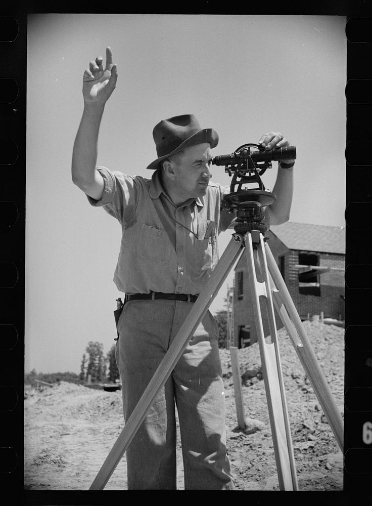 Surveyor at Greenbelt, Maryland, working in a model community planned by the Surburban Division of the United States…