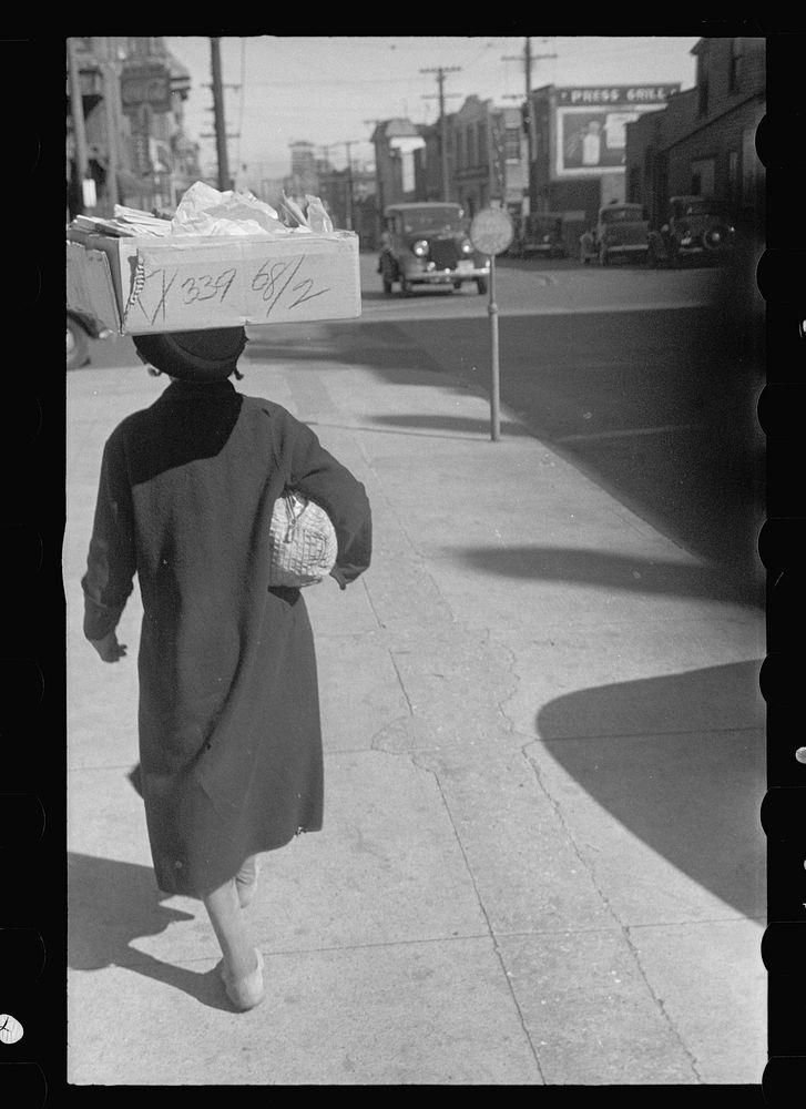 [Untitled photo, possibly related to:  woman carrying groceries, Newport News, Virginia]. Sourced from the Library of…