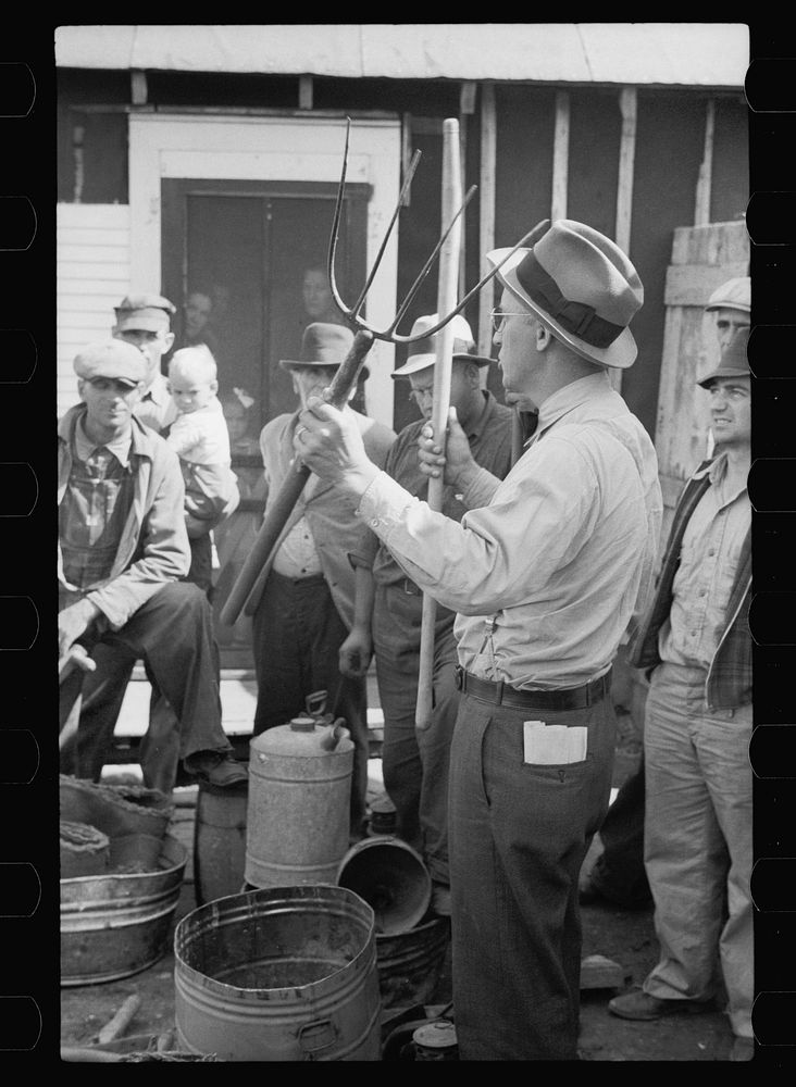 Auctioneer trying to sell pitchfork, Tenstrike, Minnesota. Sourced from the Library of Congress.