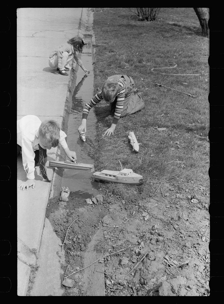 [Untitled photo, possibly related to: Children playing with boats, Grundy Center, Iowa]. Sourced from the Library of…