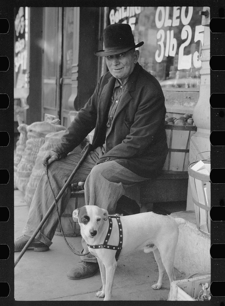 [Untitled photo, possibly related to: Man and dogs in front of grocery store, Robinson, Illinois]. Sourced from the Library…