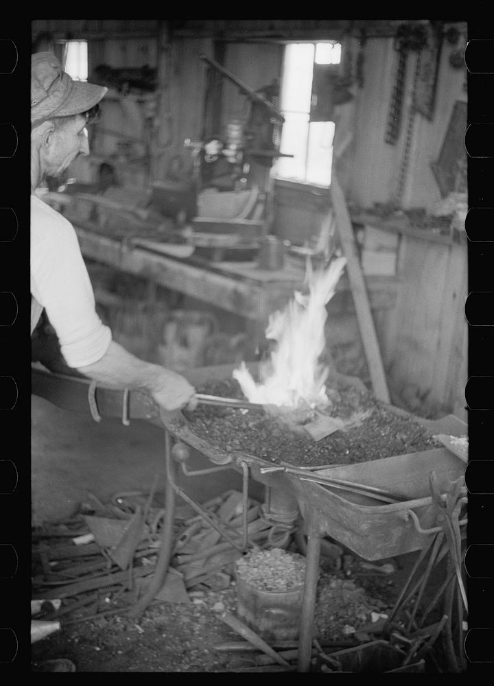 [Untitled photo, possibly related to: Blacksmith heating plow point, Southeast Missouri Farms]. Sourced from the Library of…