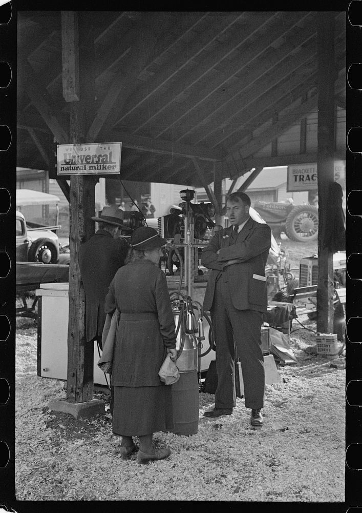 Salesman explaining new milking machine, State Fair, Rutland, Vermont. Sourced from the Library of Congress.