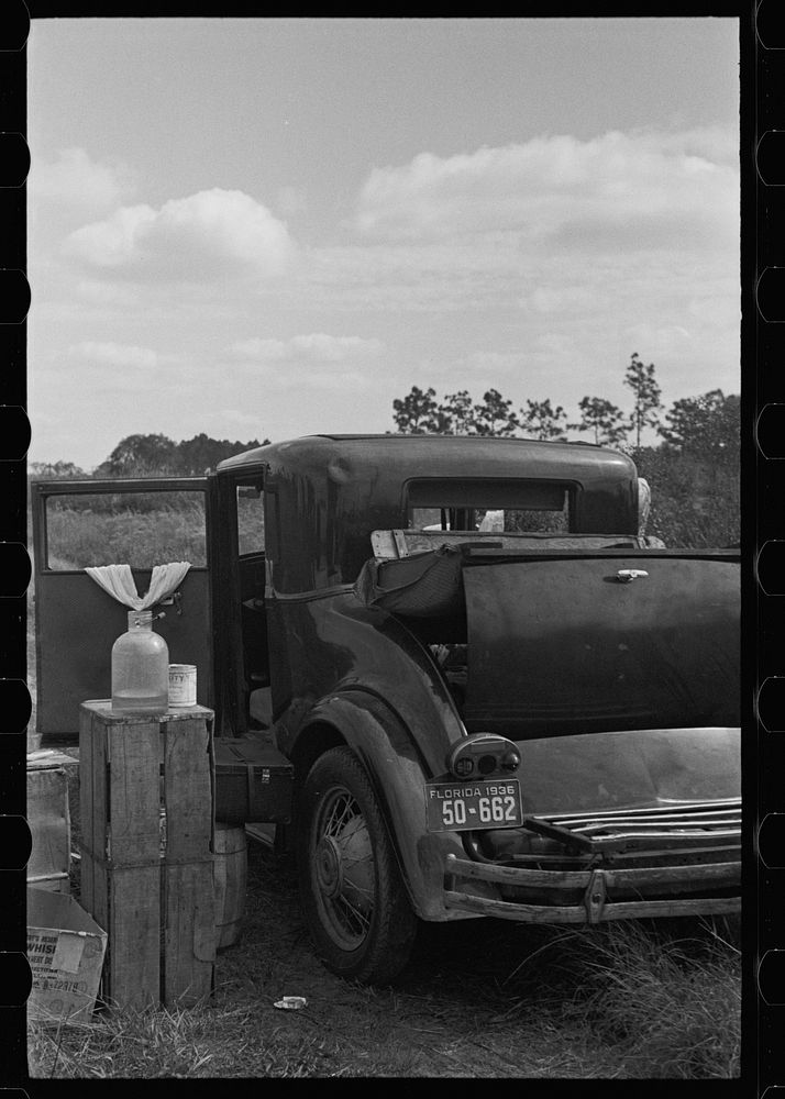 Car used by migratory agricultural workers, the rear of which has been fixed up as a bed, near Winter Haven, Florida.…