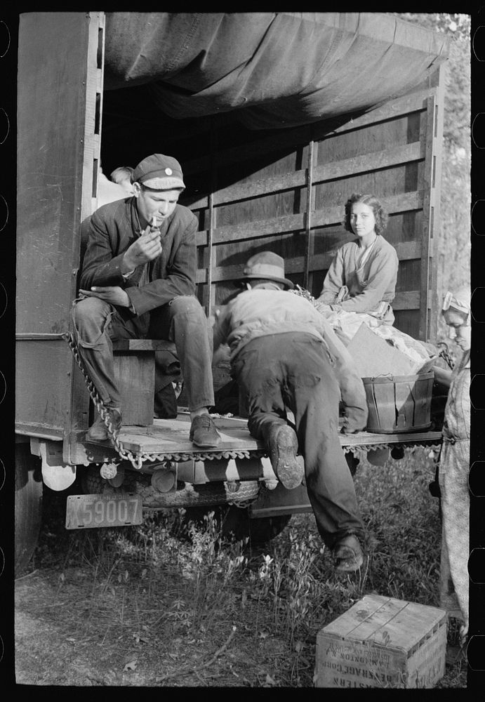 [Untitled photo, possibly related to: Cranberry pickers getting into truck that will carry them back to Philadelphia…