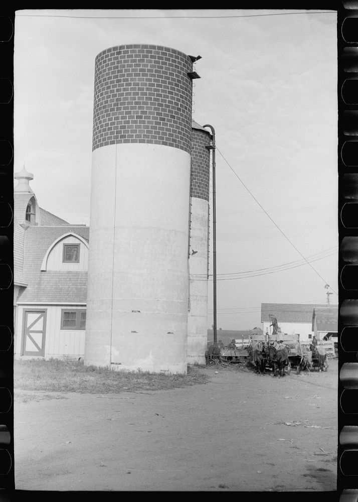 [Untitled photo, possibly related to: Silo and barn, Brandtjen Dairy Farm, Dakota County, Minnesota]. Sourced from the…