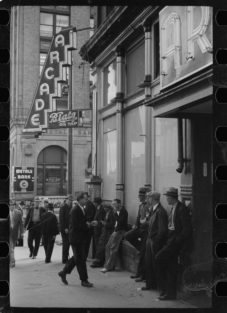 Men lounging in front of the arcade, Butte, Montana. Sourced from the Library of Congress.