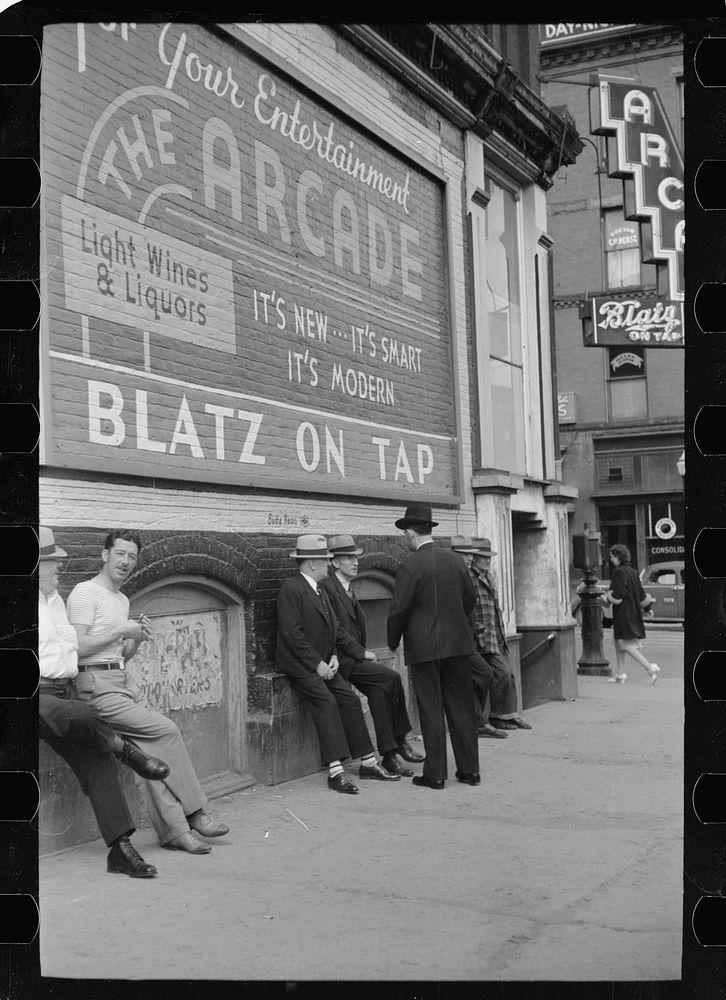 [Untitled photo, possibly related to: Men lounging in front of arcade, Butte, Montana]. Sourced from the Library of Congress.