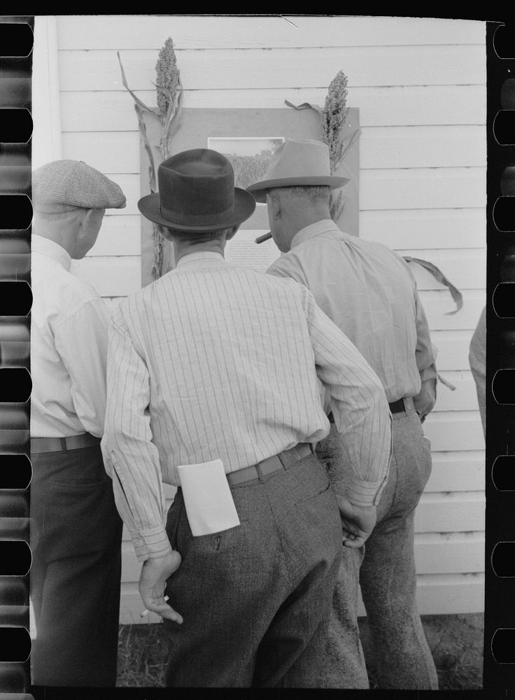 Farmers at sorghum exhibit, U.S. Experiment Station, Akron, Colorado. Sourced from the Library of Congress.