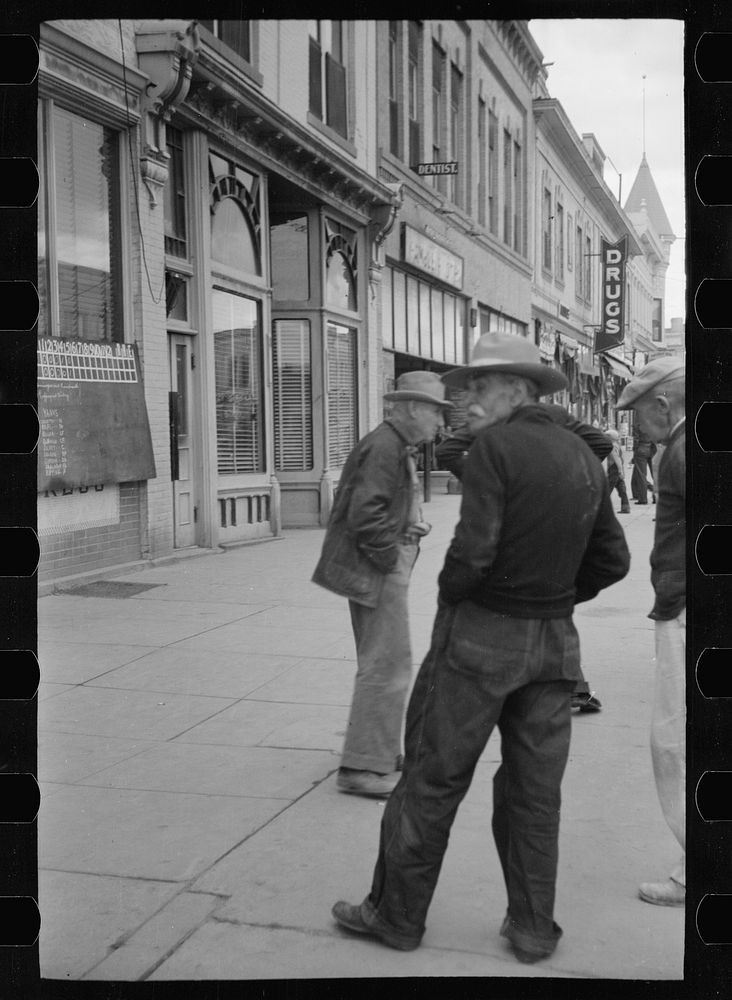 [Untitled photo, possibly related to: Men watching World Series baseball scores on main street, Montrose, Colorado]. Sourced…