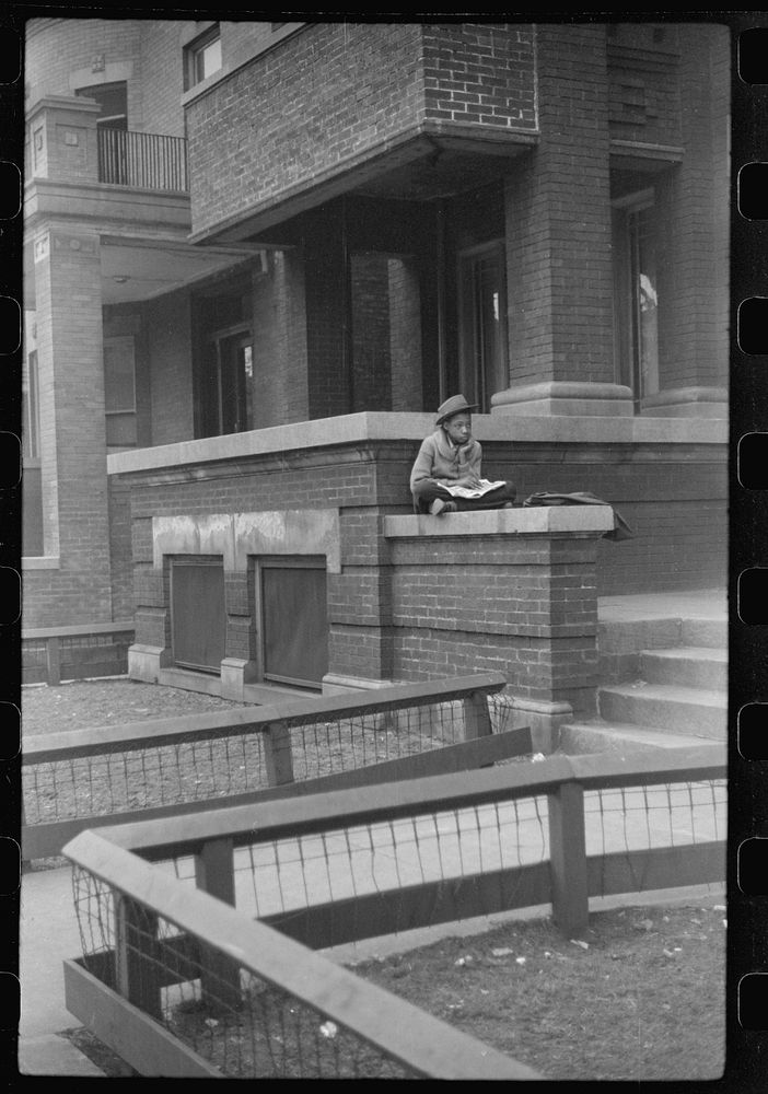 Child in front of apartment building in the better section of the Black Belt, Chicago, Illinois. Sourced from the Library of…
