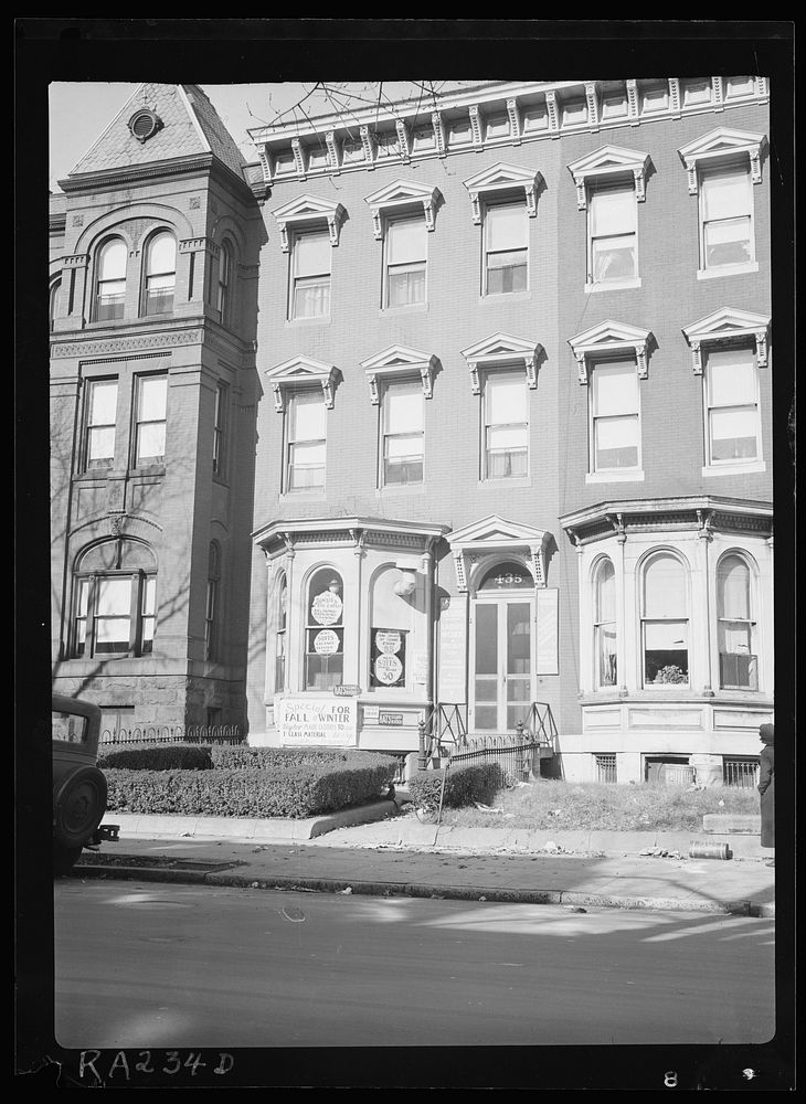 View showing tailor shop carved into brick building, another example of "blight." Washington, D.C.. Sourced from the Library…