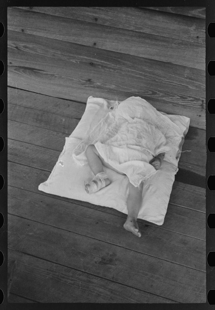 Squeakie asleep (Othel Lee Burroughs). Son of a Hale County, Alabama cotton sharecropper. Sourced from the Library of…
