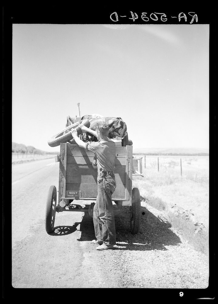 Drought refugees from South Dakota on highway making sure that nothing falls off the trailer to the Pacific Coast. Montana.…