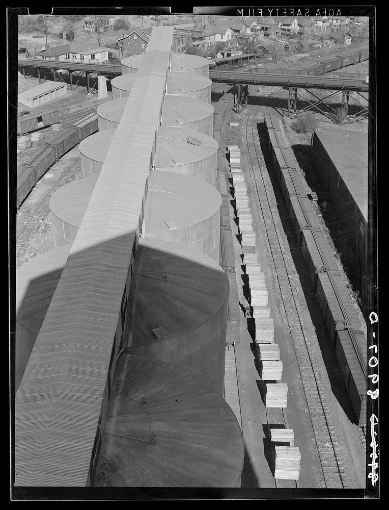 Tops of grain elevators, stacks of lumber, freight cars. Omaha, Nebraska. Sourced from the Library of Congress.