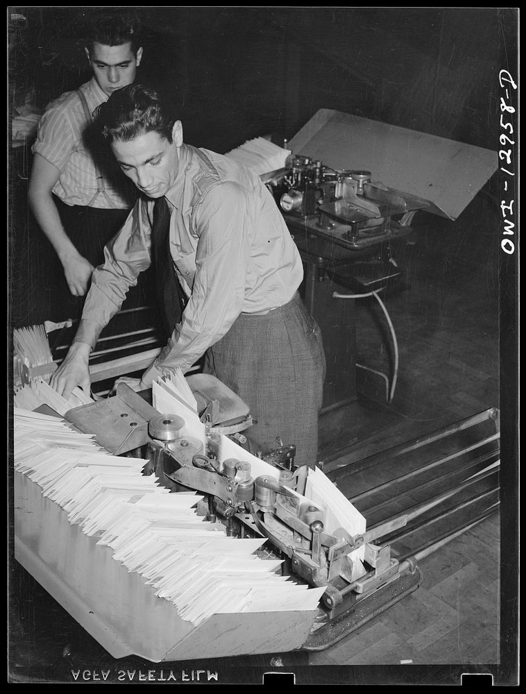 Washington, D.C. Putting mail through a cancelling machine at the main post office. Sourced from the Library of Congress.