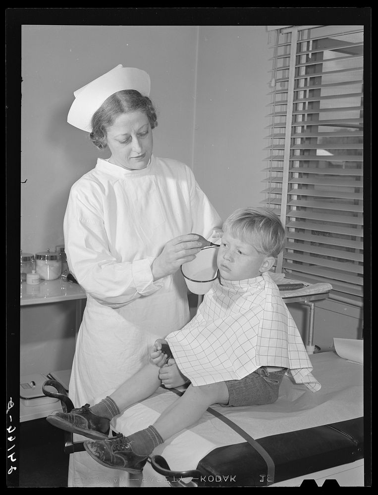 Child being treated in health clinic. Tulare migrant camp. Visalia, California. Sourced from the Library of Congress.