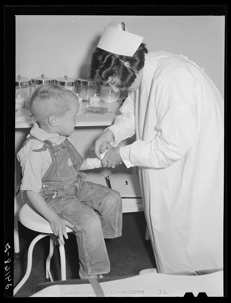 [Untitled photo, possibly related to: Child being treated in health clinic. Tulare migrant camp. Visalia, California].…