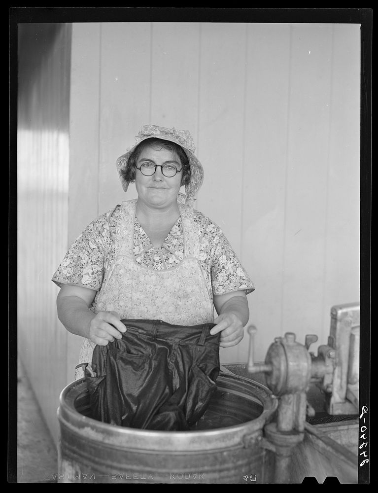 Woman washing clothes. Tulare migrant camp. Visalia, California. Sourced from the Library of Congress.
