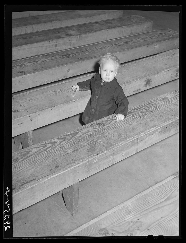 Child in recreation hall. Tulare migrant camp. Visalia, California. Sourced from the Library of Congress.