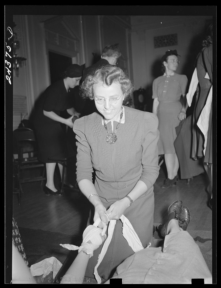 [Untitled photo, possibly related to: First aid class, American Red Cross, New York City. Demonstrating splint on fractured…