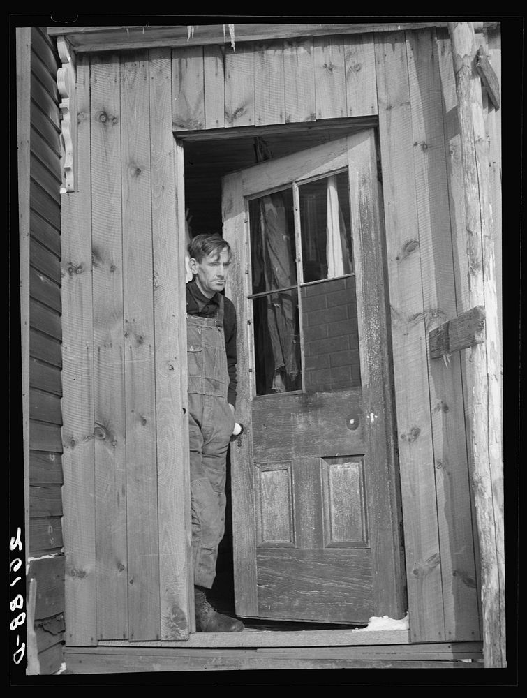 Fred Ess in the door of his farmhouse. Dalton, New York, Allegany County. Sourced from the Library of Congress.