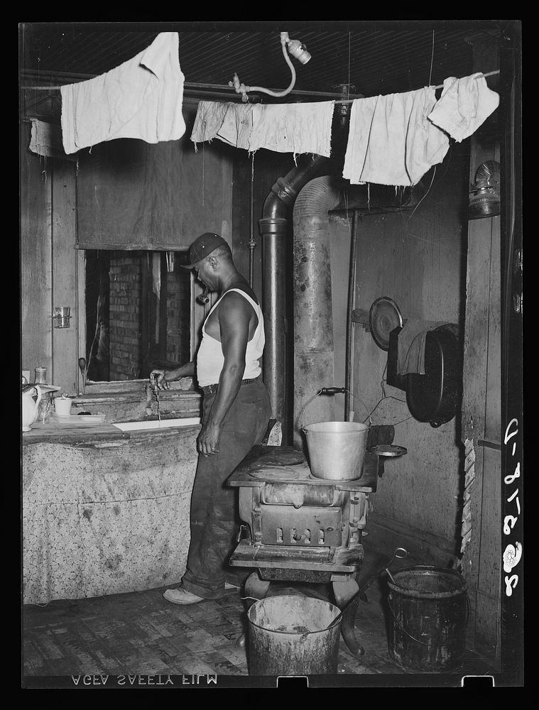 Steel worker in kitchen of  apartment. Midland, Pennsylvania. Sourced from the Library of Congress.