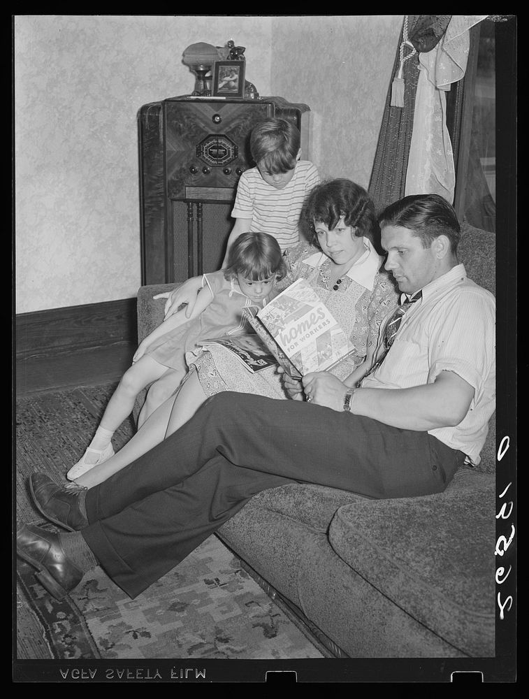 Clifford Shorts and family reading about homes for workers. Aliquippa, Pennsylvania. Sourced from the Library of Congress.
