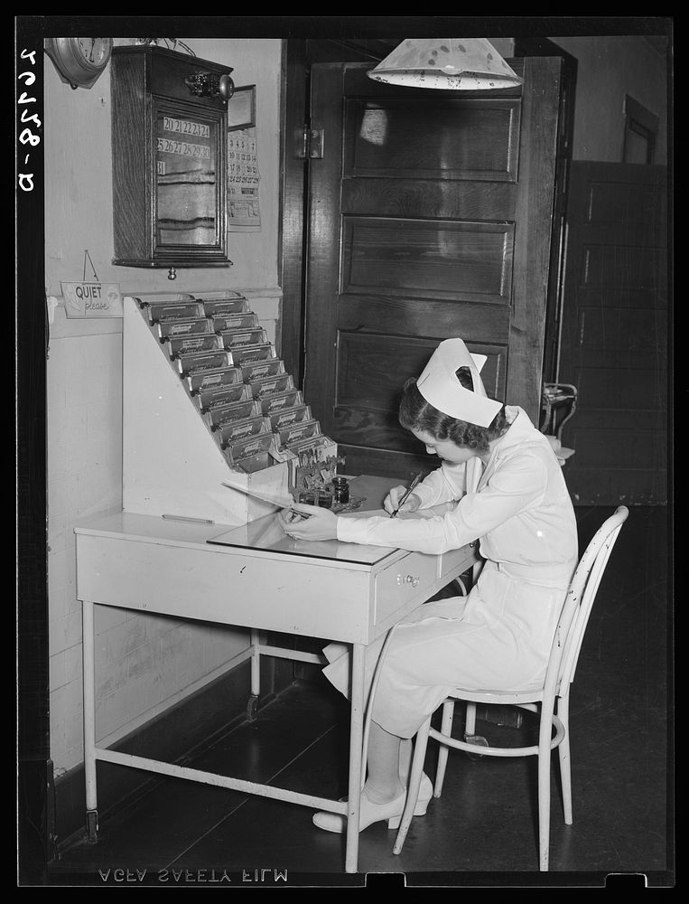 Nurse writing up charts. Herrin Hospital (private). Herrin, Illinois. Sourced from the Library of Congress.