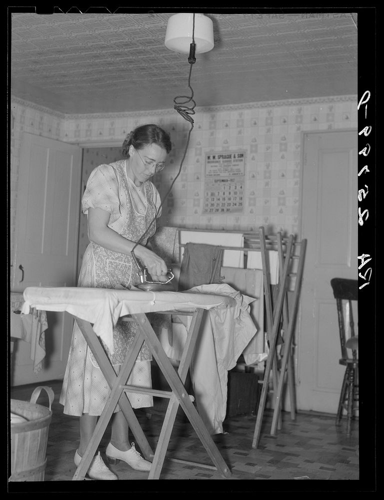 Hired girl ironing. McNally farm, Kirby, Vermont. Sourced from the Library of Congress.