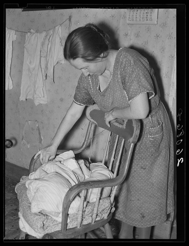 Mrs. Fred Stein, wife of farmer, cannot afford a cradle for her little girl. Garrett County, Maryland. Sourced from the…