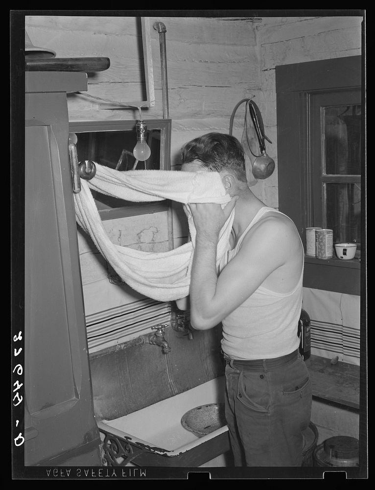 Cowhand using roller towel. Quarter Circle 'U' Ranch, Montana. Sourced from the Library of Congress.