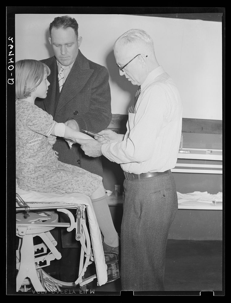 Doctor giving neoarsphenamine treatment under state program, combatting syphilis. Herrin Hospital, Herrin, Illinois. Sourced…