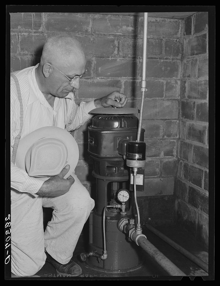 County agent with electric waterpump made possibly by Rural Electrification Adiministration. Grundy County, Iowa. Sourced…