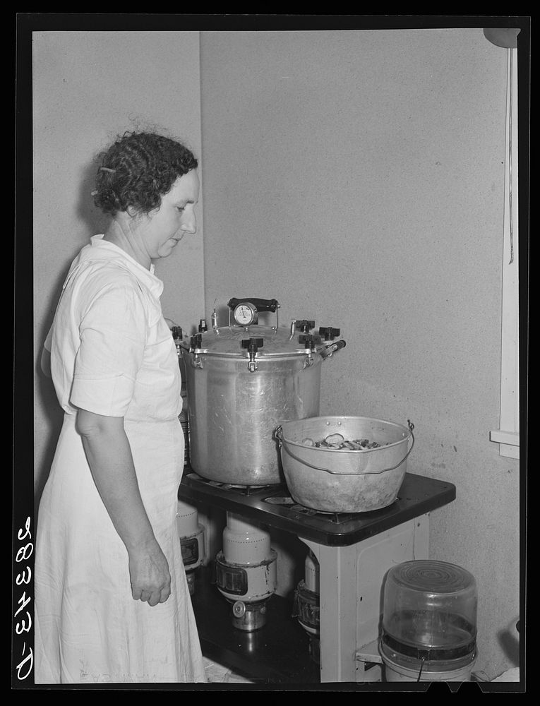 Wife of FSA (Farm Security Administration) resettlement borrower preserving vegetables in her home at San Luis Valley Farms…