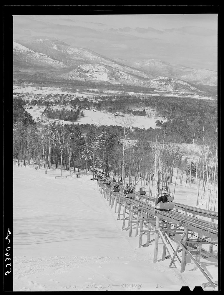 North Conway, New Hampshire, from Cranmore Mountain. Presidential range of White Mountains in distance. Skiers are taken up…