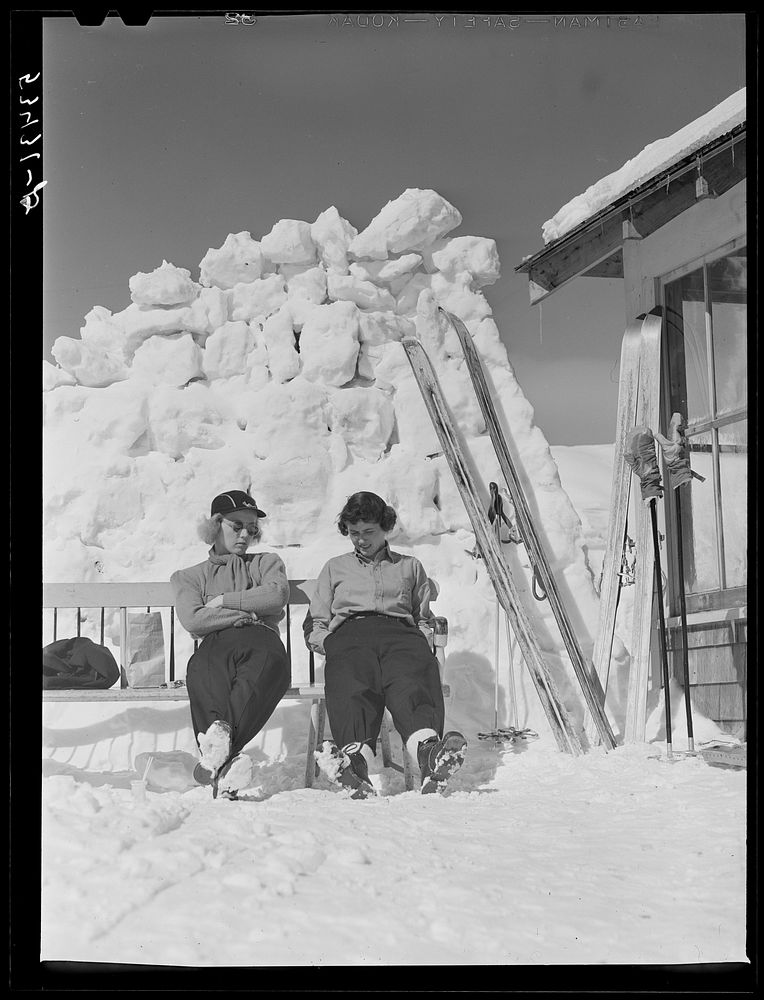 Skiers relaxing outside of lodge. North Conway, New Hampshire. Sourced from the Library of Congress.