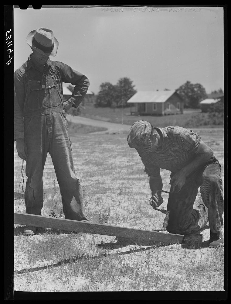 Farmers working outside woodworking shop. Community service center. Faulkner County, Centerville, Arkansas (see general…