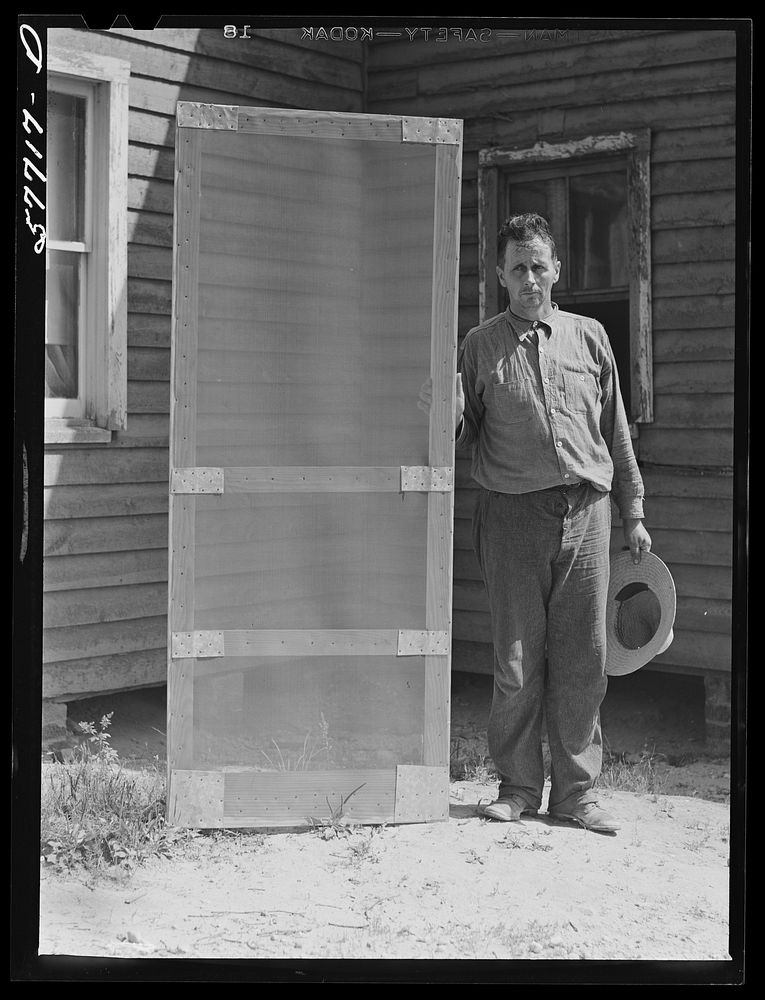 Door frame with screen wire assembled ready to fasten on hinge strip.  Screening demonstration. Charles County, La Plata…