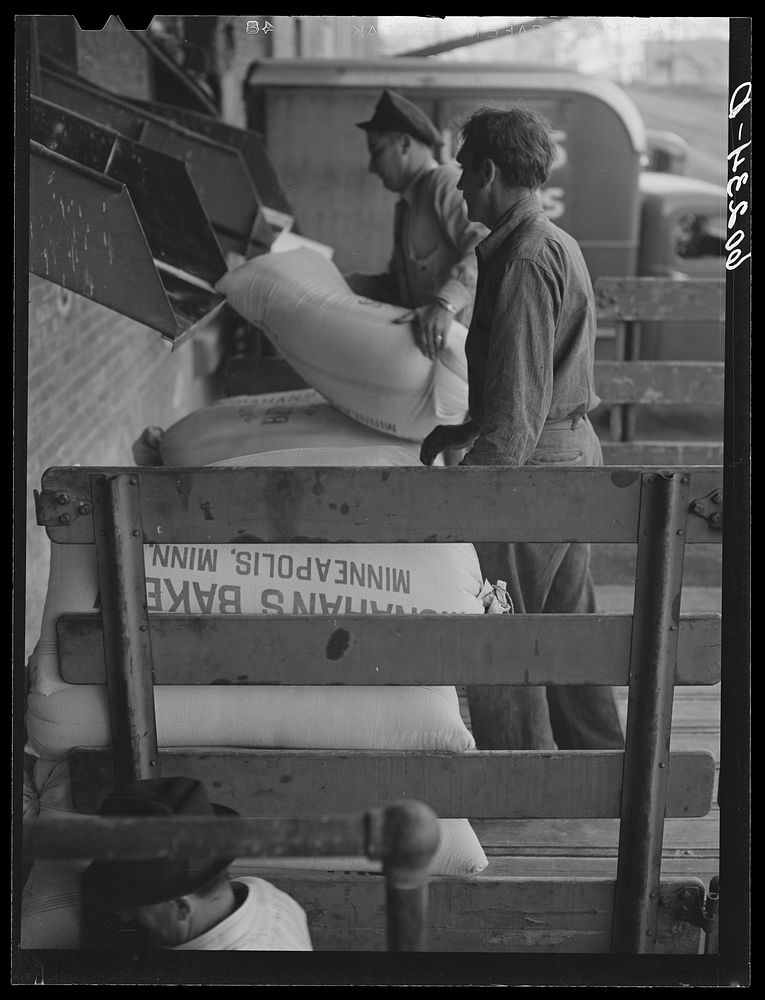 Loading truck with daily supply of flour for local bakery. Minneapolis, Minnesota. Sourced from the Library of Congress.