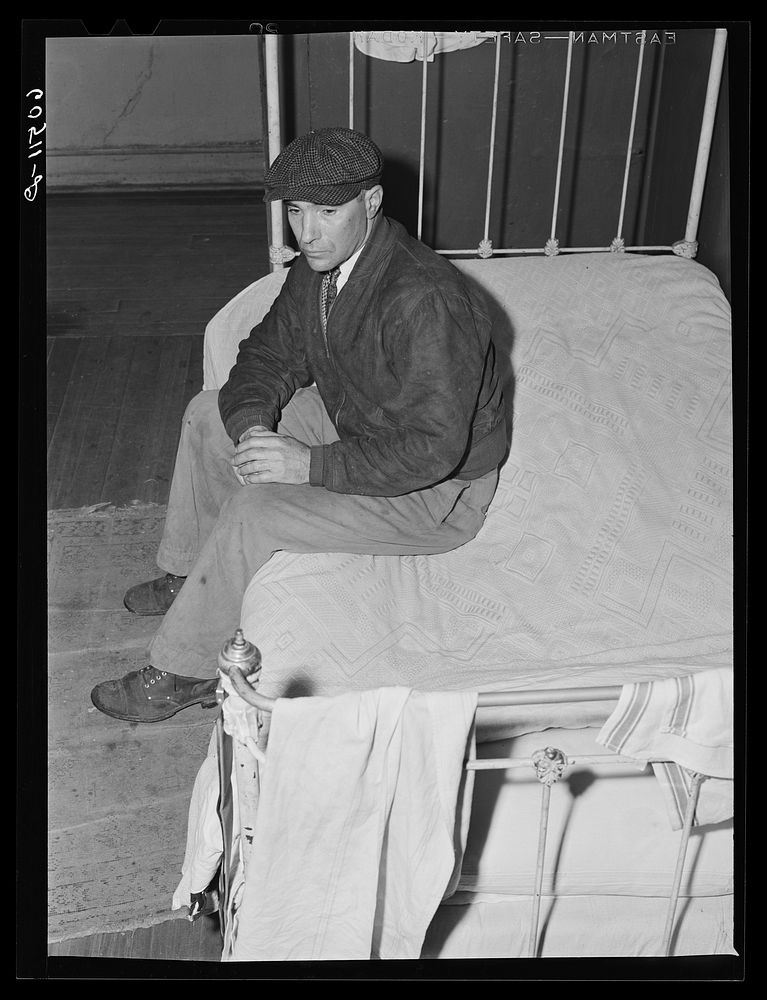 Transient farm laborer in hotel room which he rents for one dollar and fifty cents a week. Dubuque, Iowa. Sourced from the…