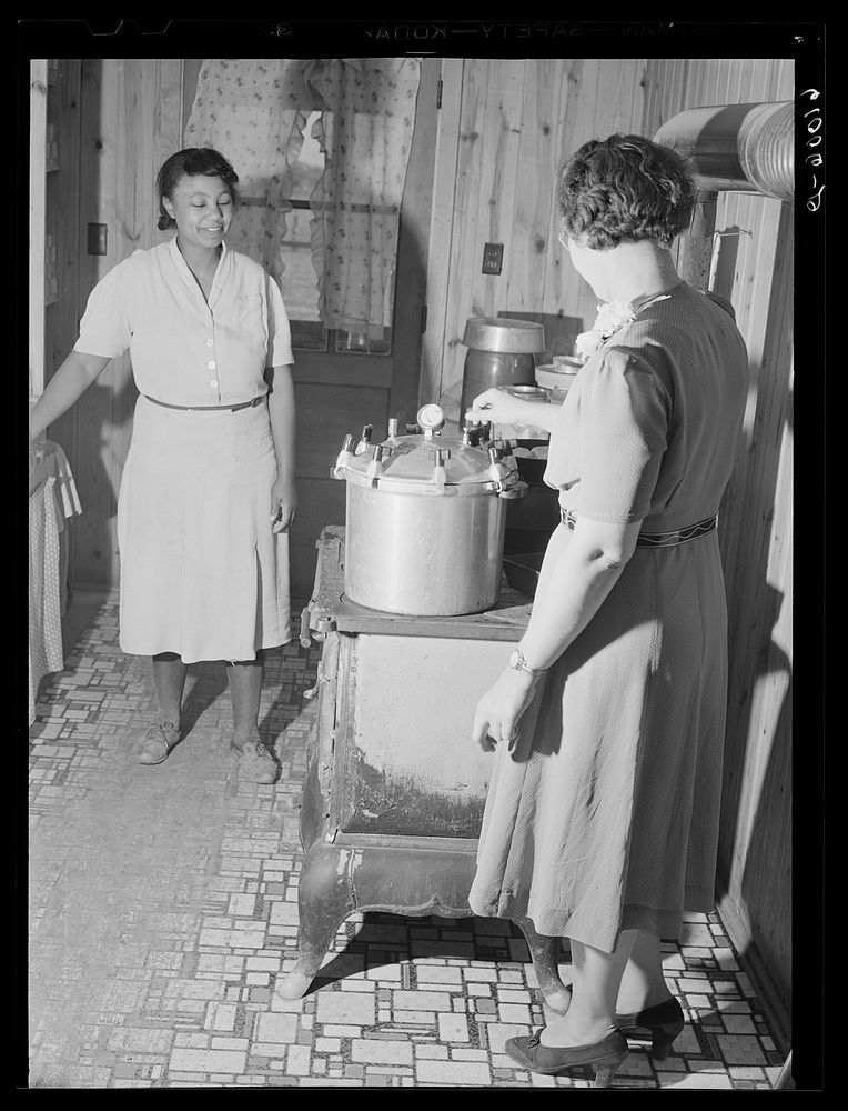 Home supervisor demonstrating use of pressure cooker. Southeast Missouri Farms. Sourced from the Library of Congress.