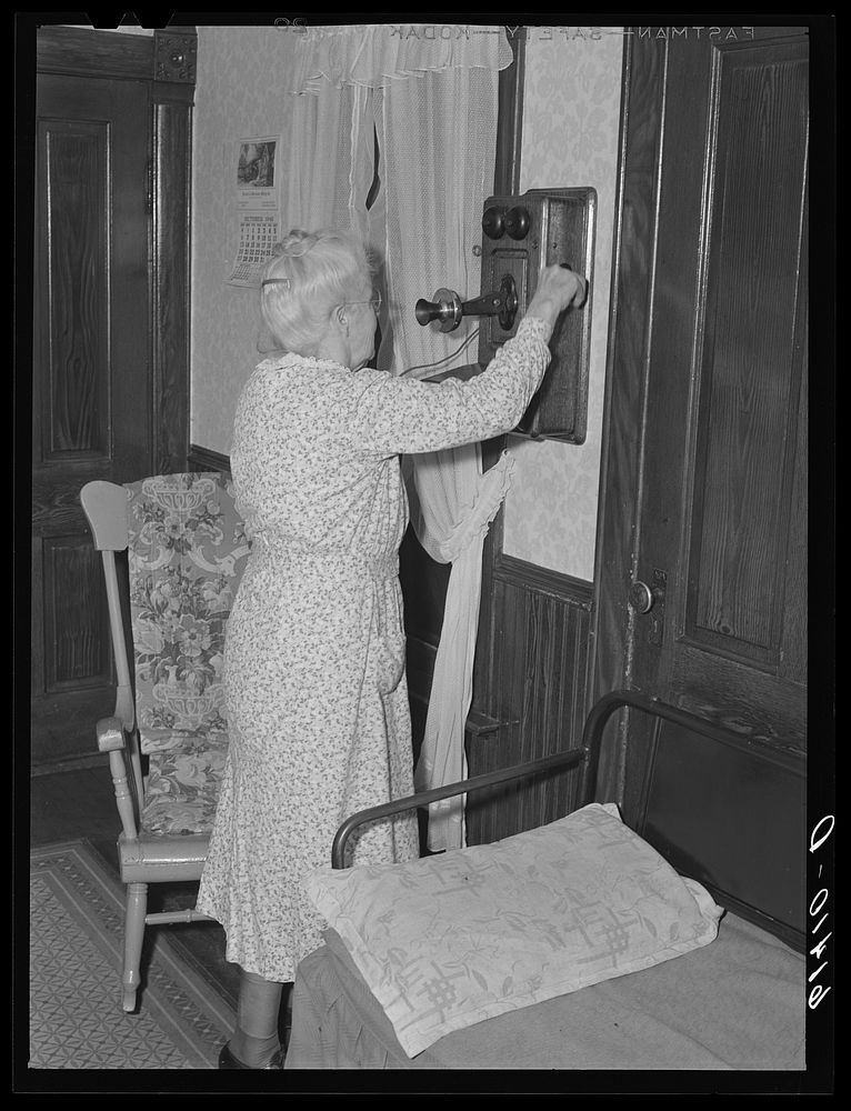 Farm woman ringing the operator. Meeker County, Minnesota. Sourced from the Library of Congress.
