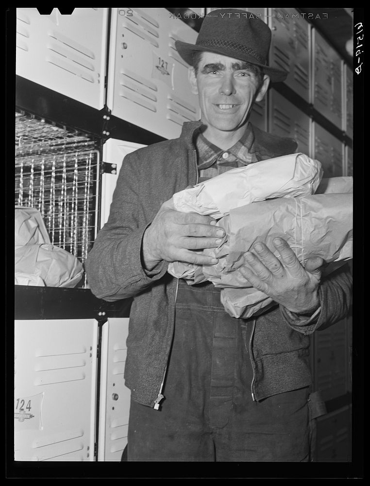 Farmer with arms full of food from cold storage locker. Hillsboro, North Dakota. Sourced from the Library of Congress.